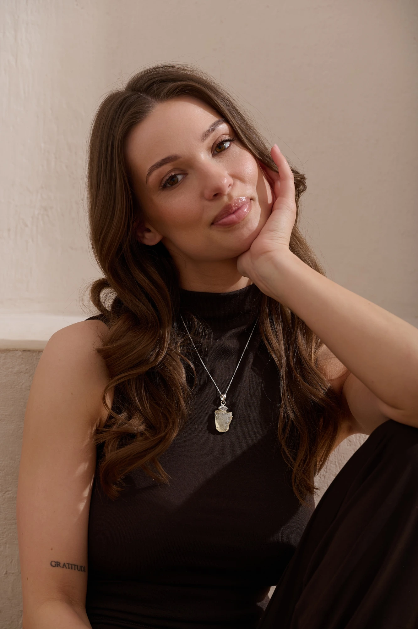 Model wearing raw crystal pendant